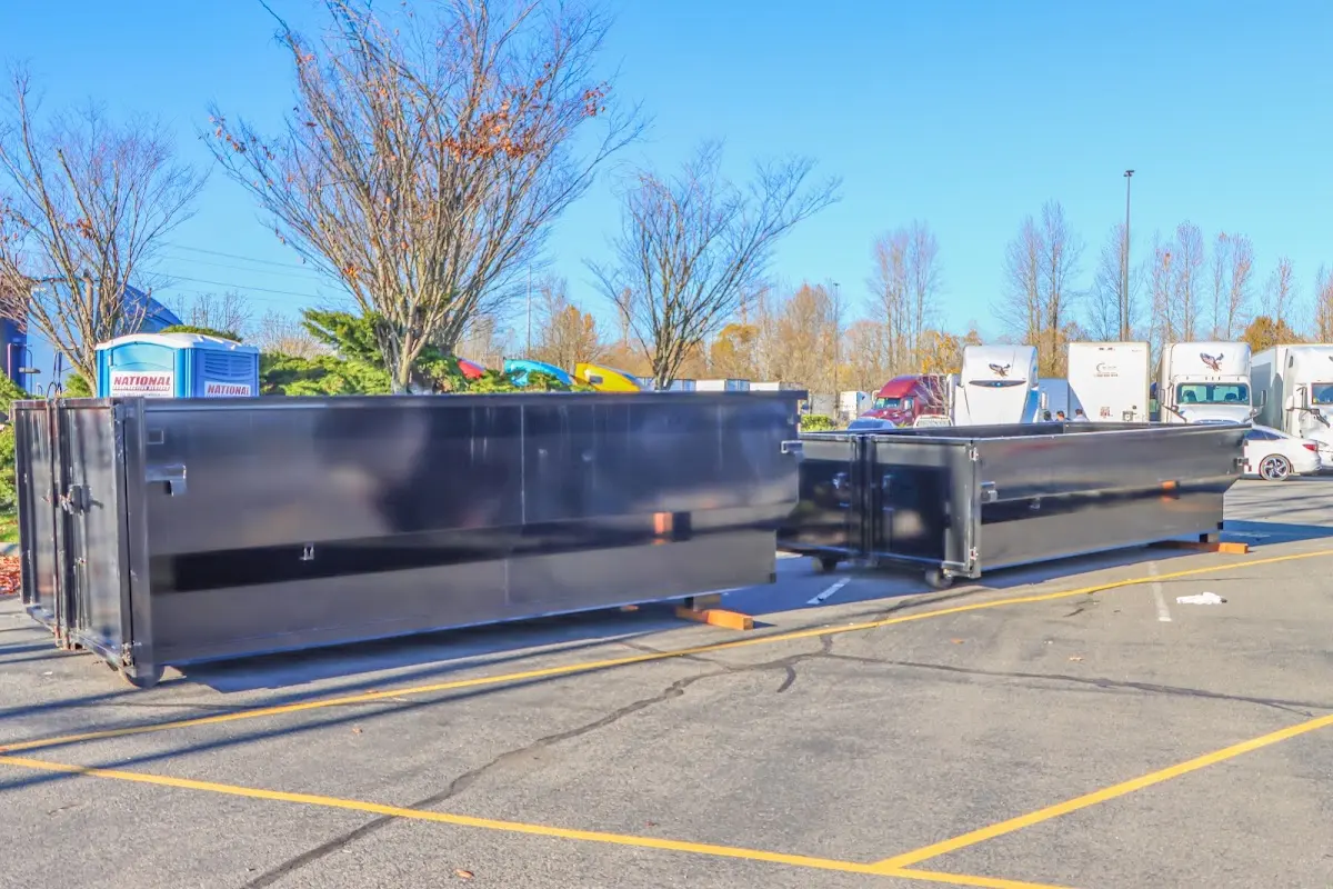 Professional dumpster rental service with roll-off container on residential driveway in Rhinelander